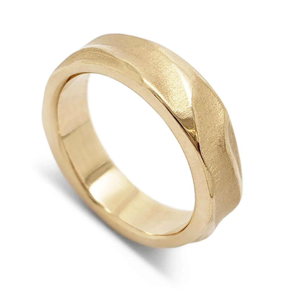 Handcarved 14kt yellow gold wedding ring with topography texture, angled view