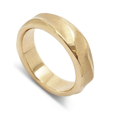 Handcarved 14kt yellow gold wedding ring with topography texture, angled view