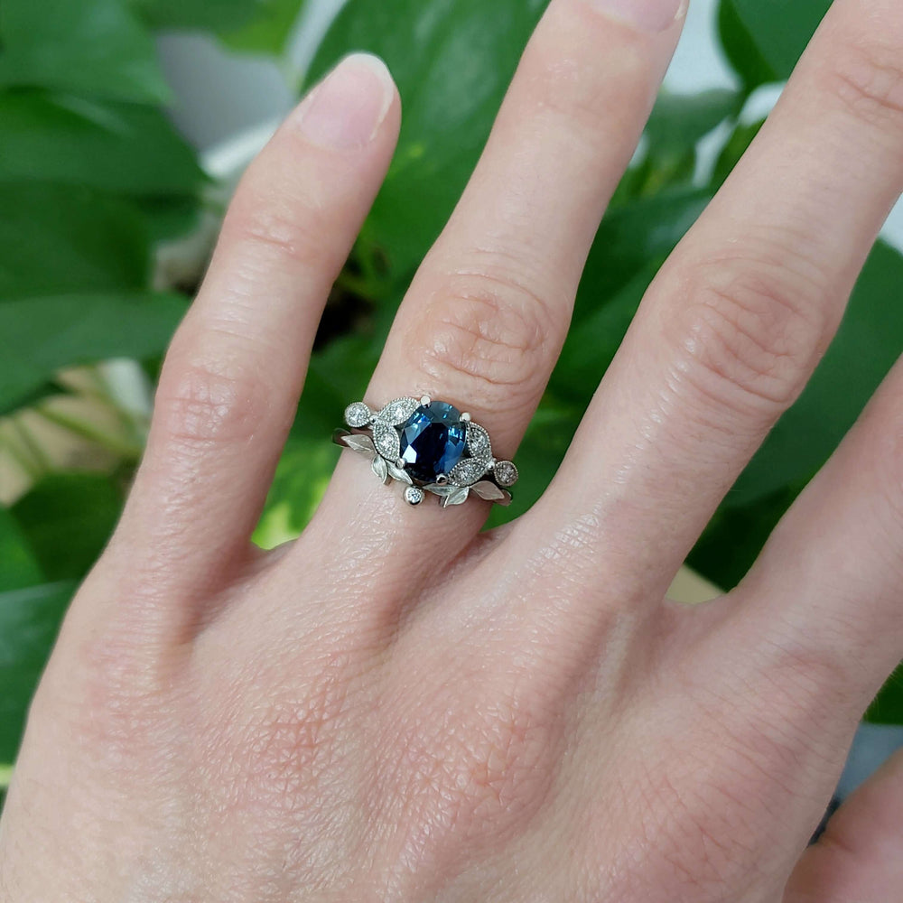 Handcrafted 14K white gold sapphire and diamond ring, worn on finger