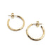 Pair of handcrafted 14K yellow gold hammered hoop earrings on white background