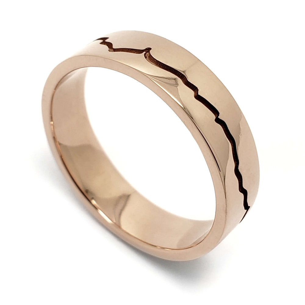 Handcrafted 14k rose gold wedding ring with mountain range engraving, high polished finish