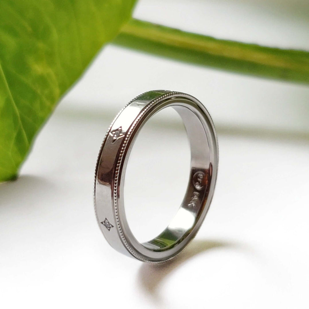 Handcrafted 14k white gold diamond wedding ring with millgrain detail, side view