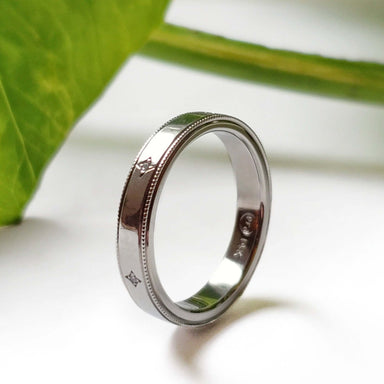 Handcrafted 14k white gold diamond wedding ring with millgrain detail, side view