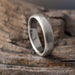 Handcrafted 14k white gold flat wedding ring with brushed texture on wood