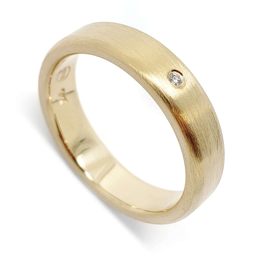 Handcrafted 14k yellow gold wedding ring with flush-set Canadian diamond and brushed finish