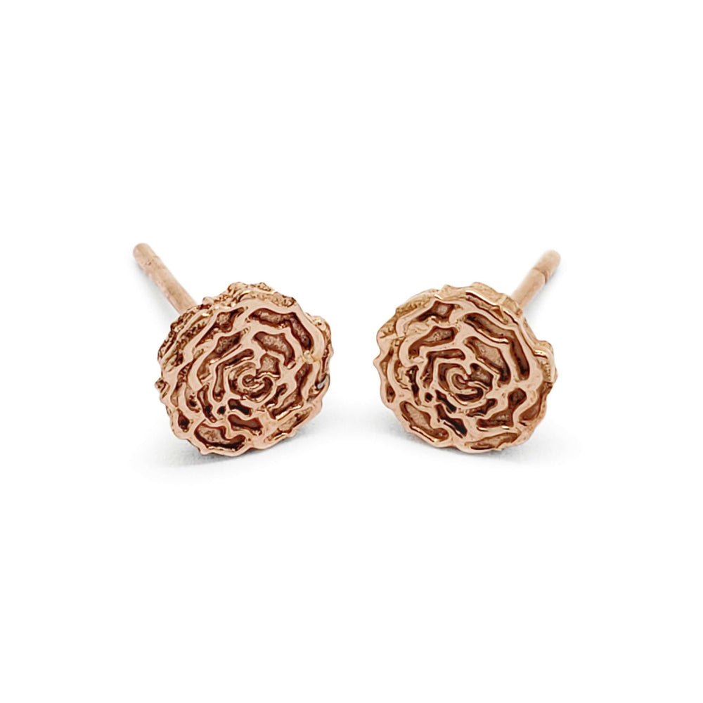 Pair of handcrafted 14kt rose gold floral rose stud earrings on white background