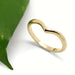 Handcrafted 14kt yellow gold chevron ring beside a green leaf
