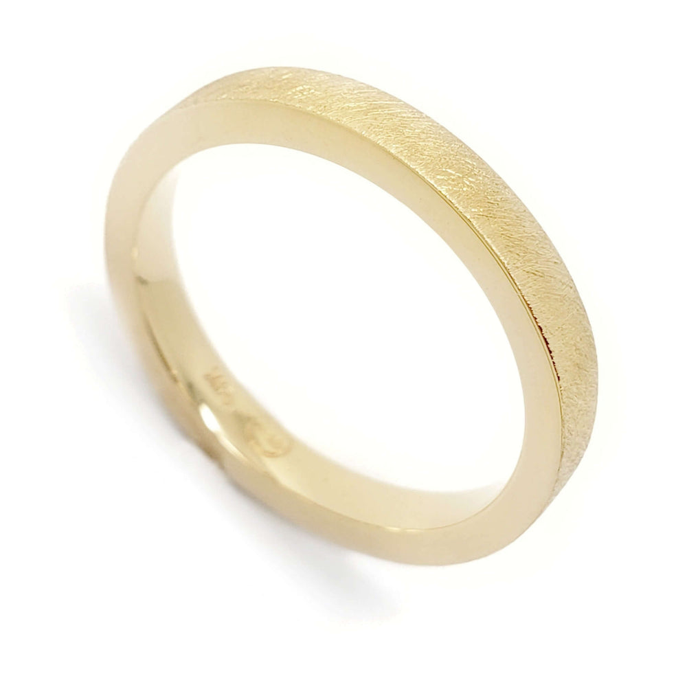 Handcrafted 14kt yellow gold wedding ring with saw blade texture and flat profile