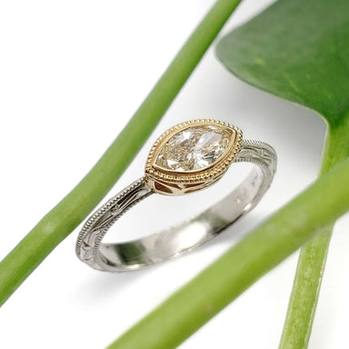 Handcrafted Leela ring with marquise champagne diamond in two-tone 14k gold, styled with green leaves