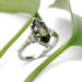 Handcrafted marquise green sapphire and diamond ring in white gold, styled with greenery