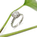 Handcrafted white gold lab diamond engagement ring with pave-set band, styled with greenery