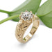 Handcrafted yellow gold engagement ring with engraved floral detail and lab diamond