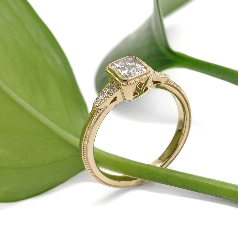 Handcrafted yellow gold engagement ring with radiant lab diamond and diamond shoulders, side view