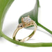 Handcrafted yellow gold lab diamond ring with marquise accents, styled with green leaf