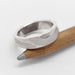 Handmade 14kt white gold topography ring displayed on a pencil