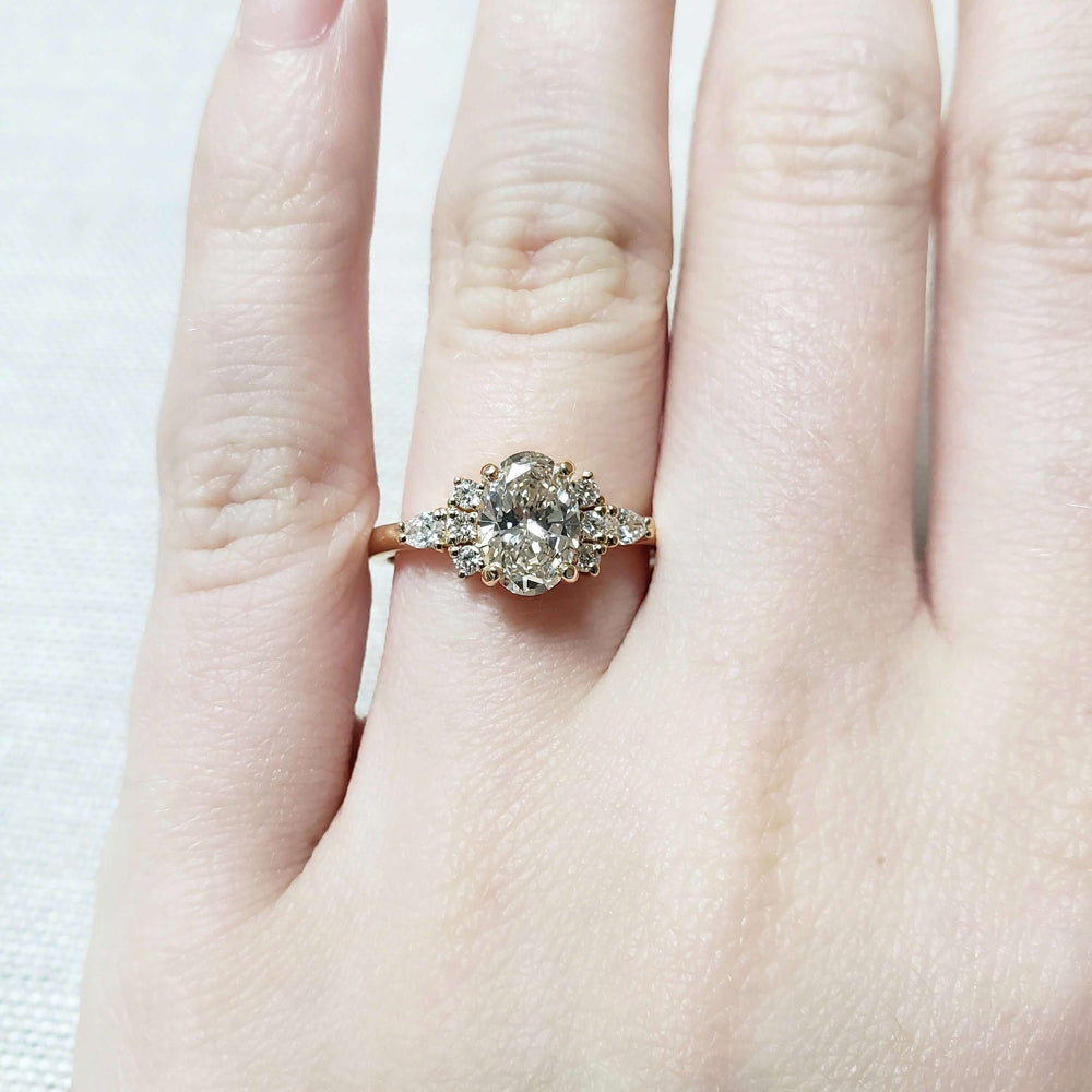 14kt yellow gold lab diamond cluster engagement ring shown on a hand