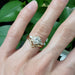 Harper lab diamond cluster engagement ring stacked with chevron band on a hand