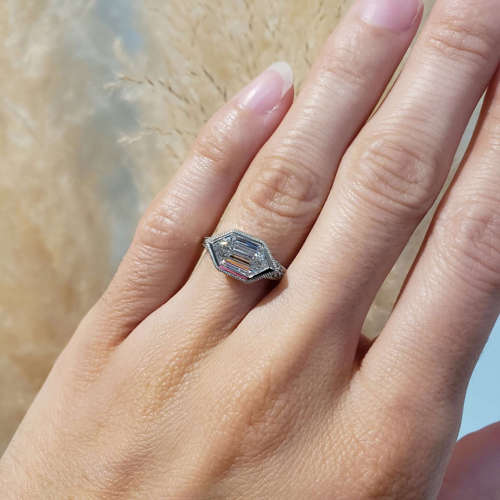 Hexagon lab diamond engagement ring in white gold shown on hand