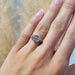 Hexagon lab diamond engagement ring in white gold shown on hand