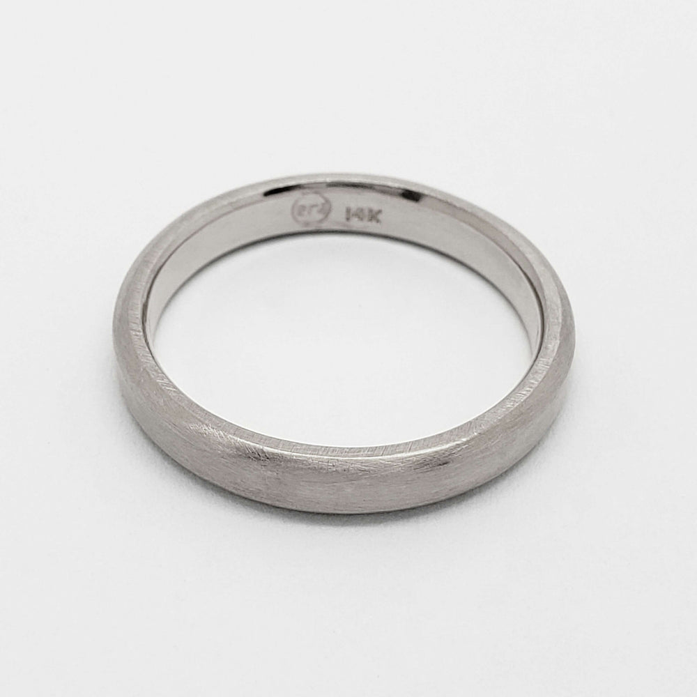 Inside view of 14k white gold wedding ring showing hallmark and brushed texture