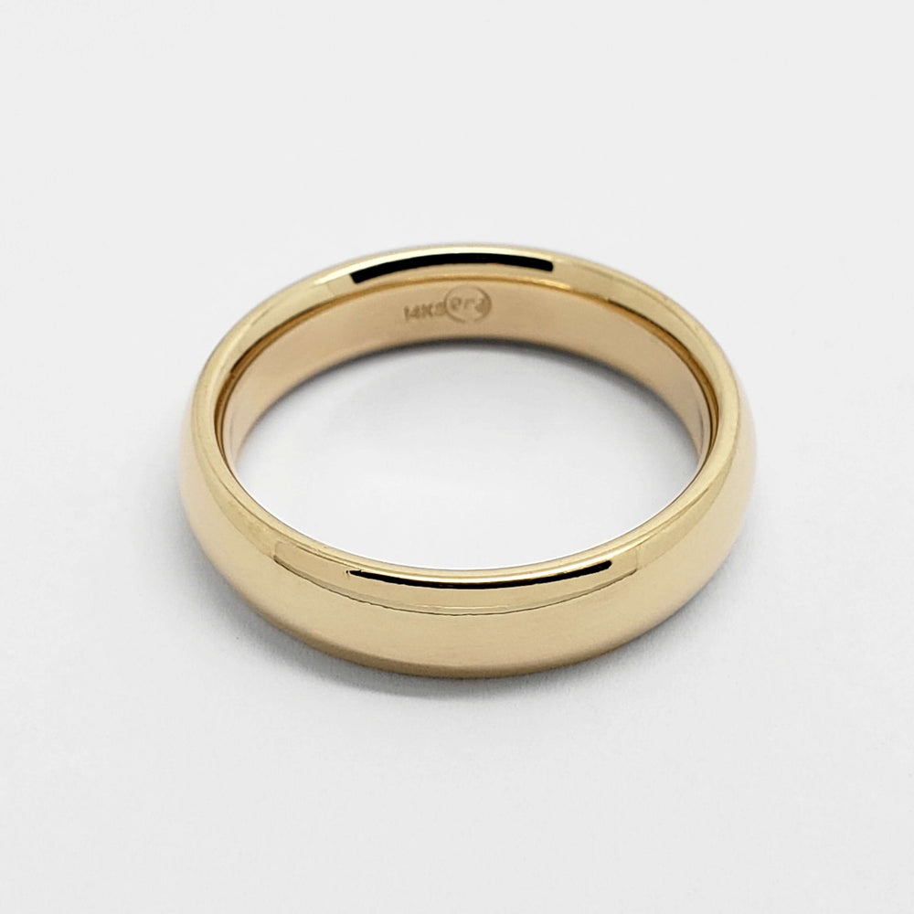Interior view of 14kt yellow gold low dome wedding ring showing hallmark