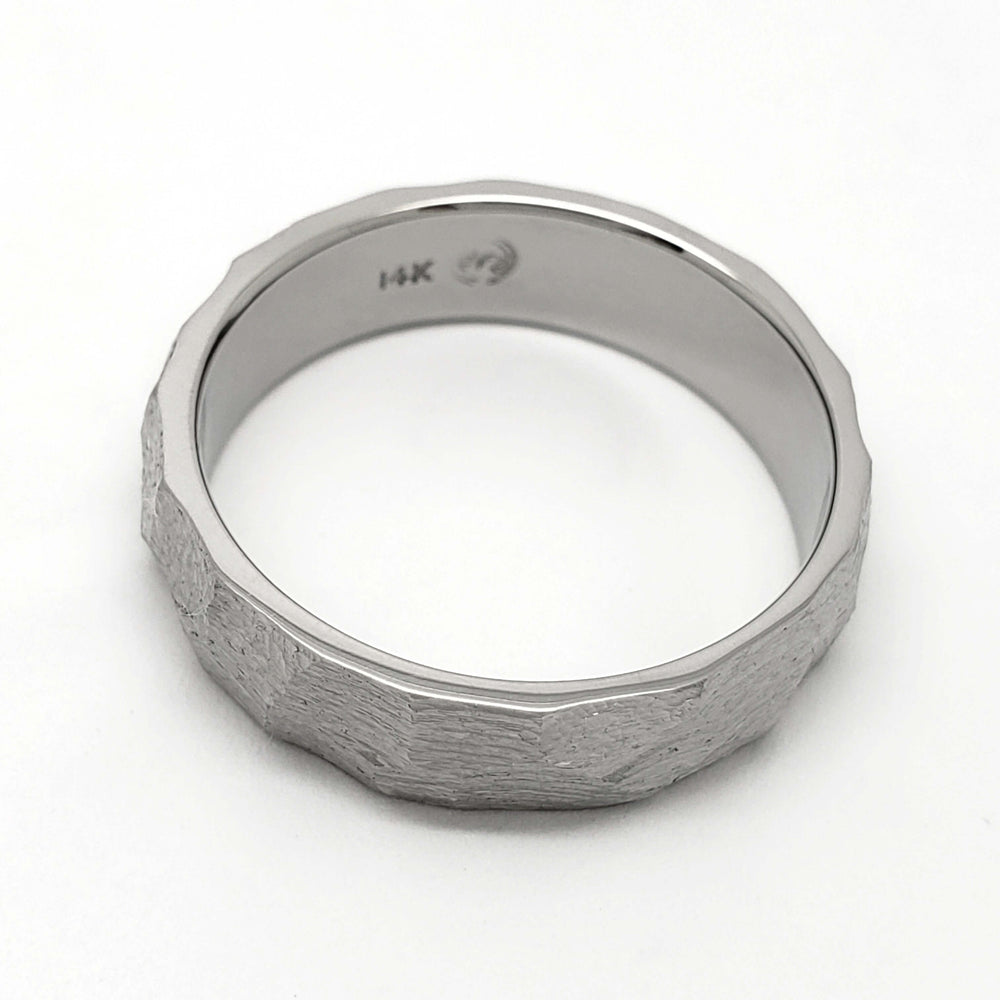 Interior view of handcrafted 14kt white gold wedding ring with faceted texture