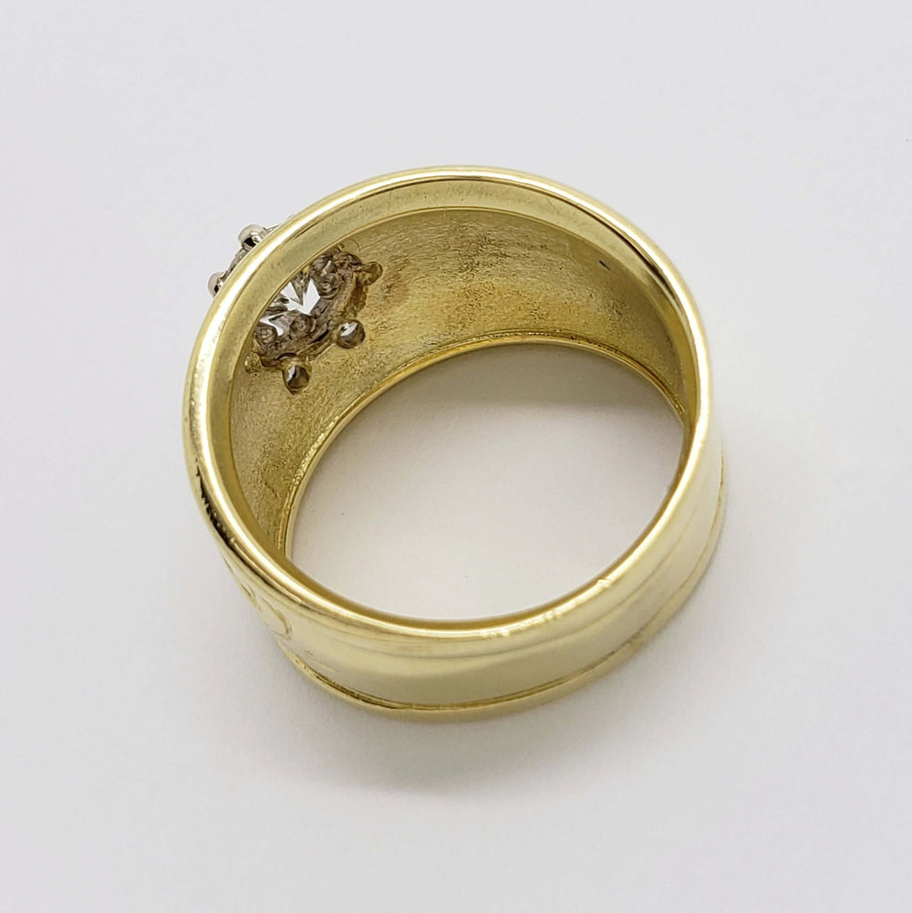 Interior view of wide 18kt yellow gold engraved vintage ring with diamond setting