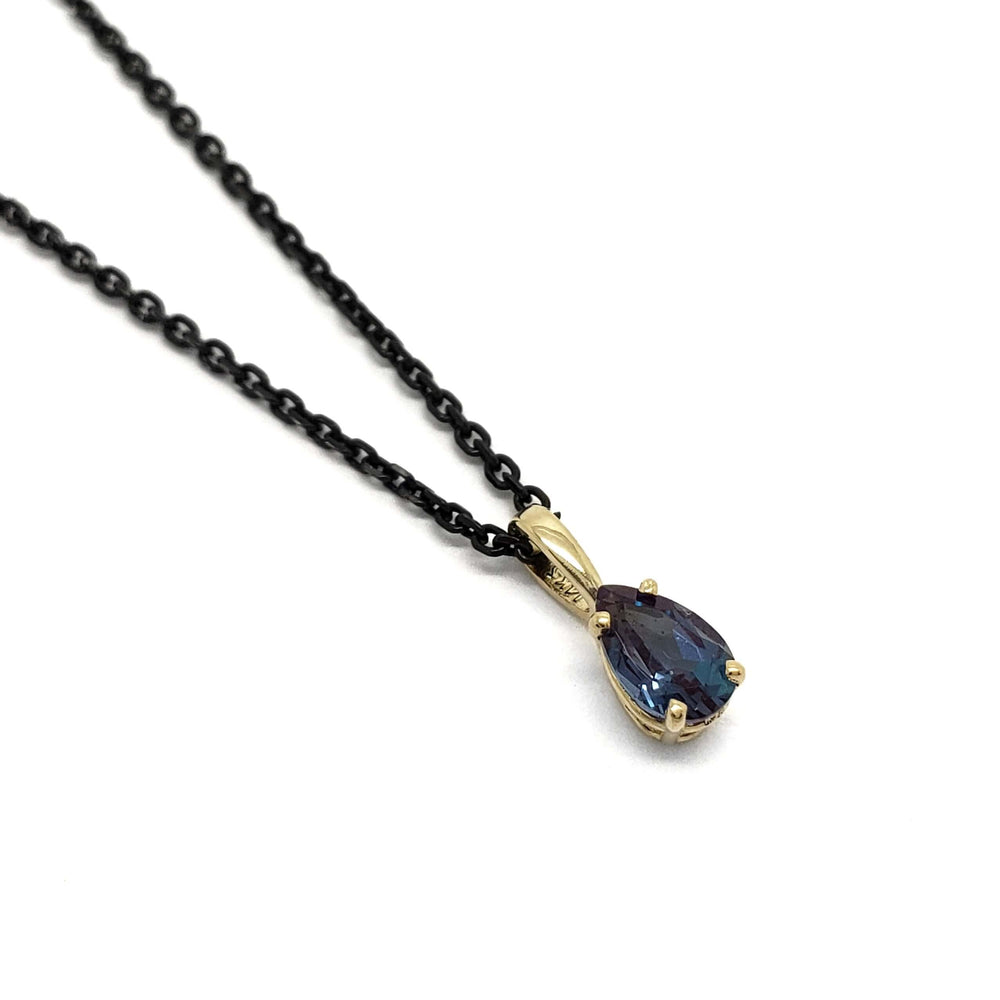 Pear cut lab alexandrite pendant in 14kt yellow gold on a black chain