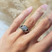 14kt white gold lab diamond and blue sapphire engagement ring shown on a hand