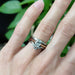 Rose gold lab diamond solitaire ring stacked with white gold and diamond bands on hand