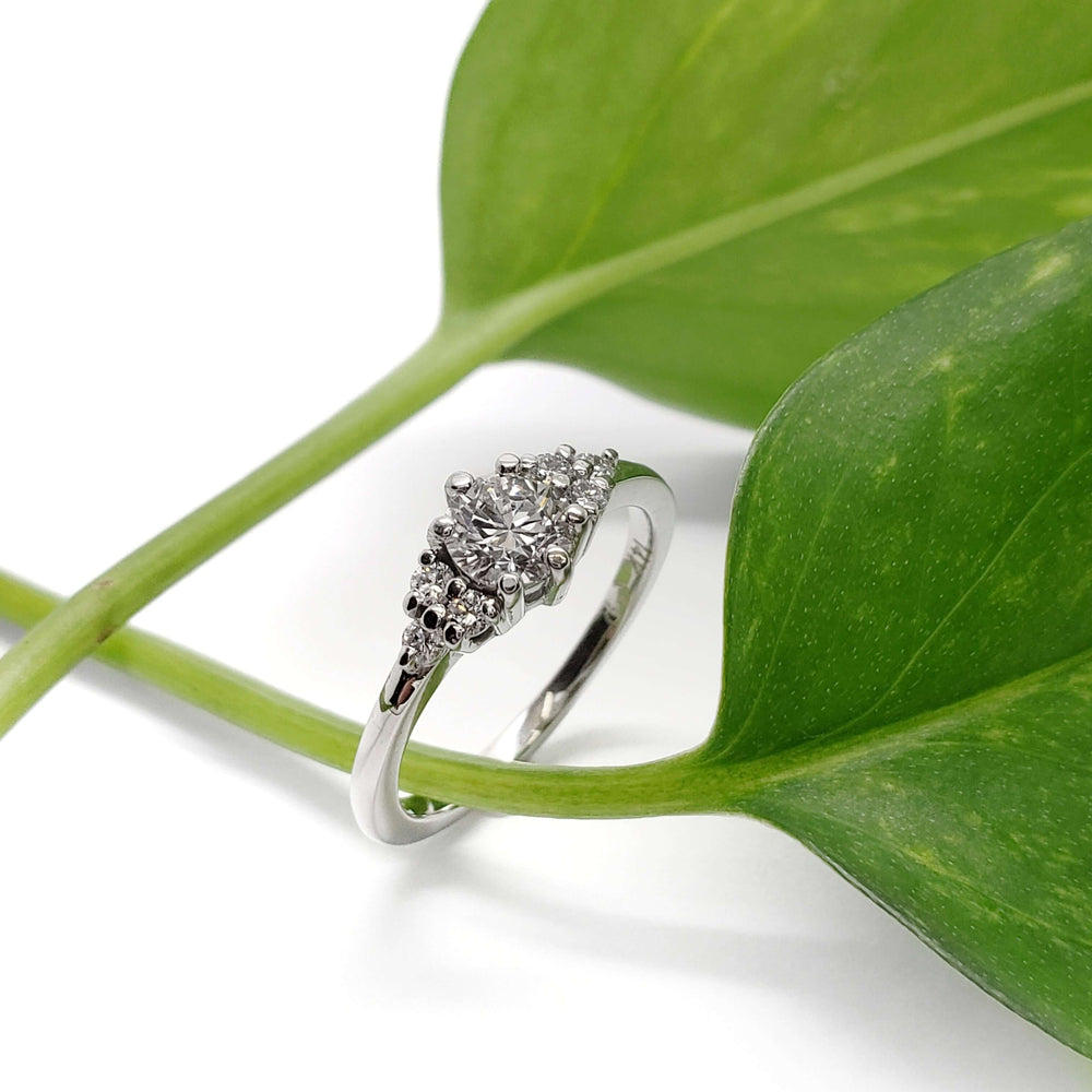 Lab diamond white gold engagement ring displayed on a green leaf