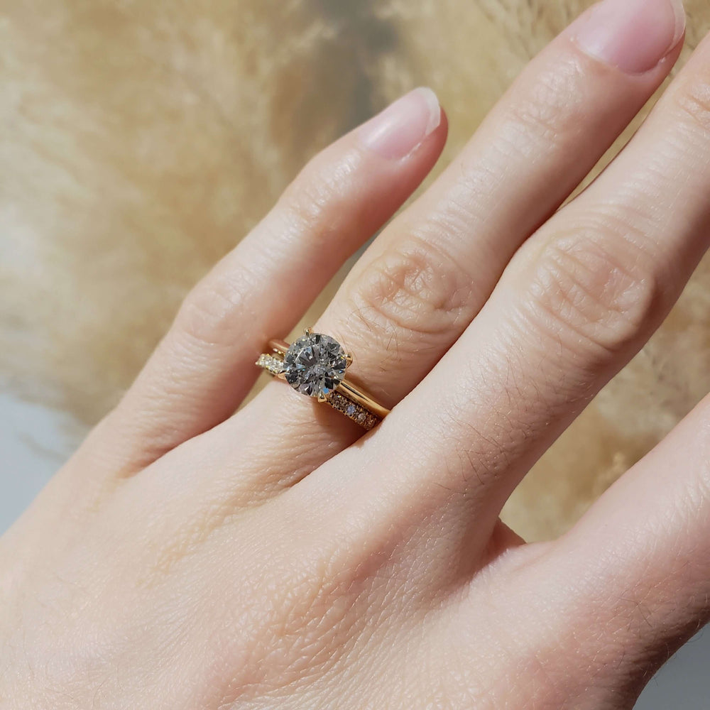 Lab diamond yellow gold wedding ring stacked with engagement ring on hand
