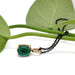 Lab emerald cabochon pendant in 14kt yellow gold with black chain, styled with green leaves