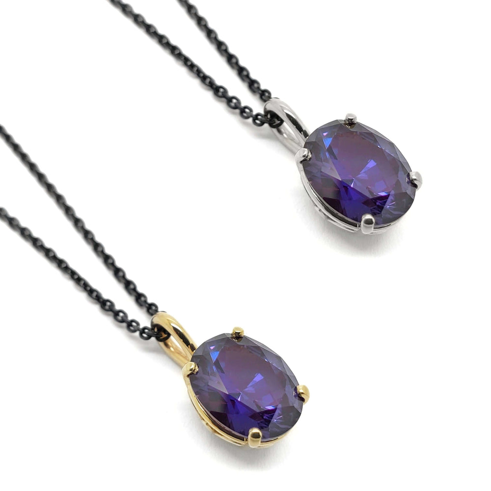 Two oval lab grown purple sapphire pendants in yellow and white 14kt gold on black chains