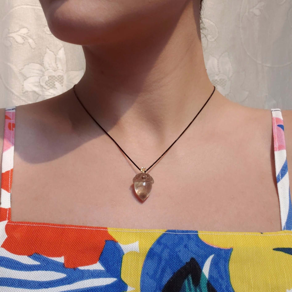 Large smoky quartz acorn pendant with 14kt gold bail worn on blackened chain
