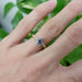 Lavender sapphire and diamond yellow gold ring worn on a hand