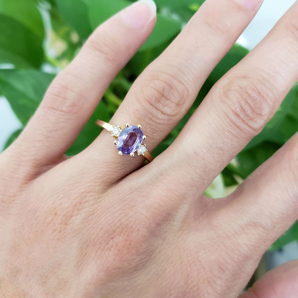 Lavender sapphire and lab diamond ring in yellow gold shown on hand