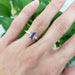 Lavender sapphire and lab diamond ring in yellow gold shown on hand