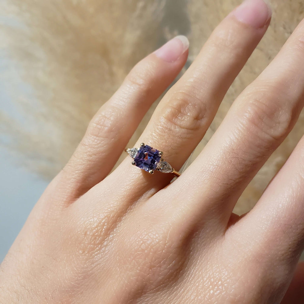 Lavender sapphire and lab diamond yellow gold ring shown on hand