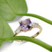 Lavender sapphire and lab diamond ring in yellow gold, shown with green leaf accent