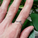 Leaf-inspired 14k white gold diamond wedding ring worn on hand