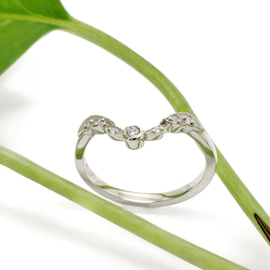 Leaf-inspired 14k white gold ring with lab diamonds, photographed with a green plant stem