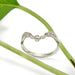 Leaf-inspired 14k white gold ring with lab diamonds, photographed with a green plant stem