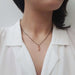Leafy champagne diamond pendant in rose gold worn on a black chain