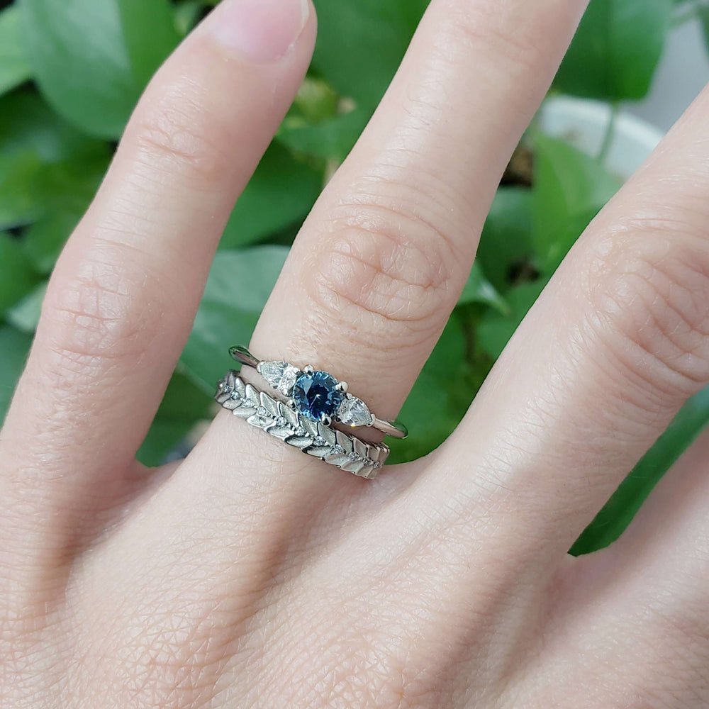 Leafy diamond wedding band stacked with blue sapphire and diamond engagement ring