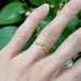 Leafy diamond wedding ring in yellow gold worn on a hand