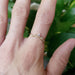 Leafy rose gold diamond wedding ring on hand, single band