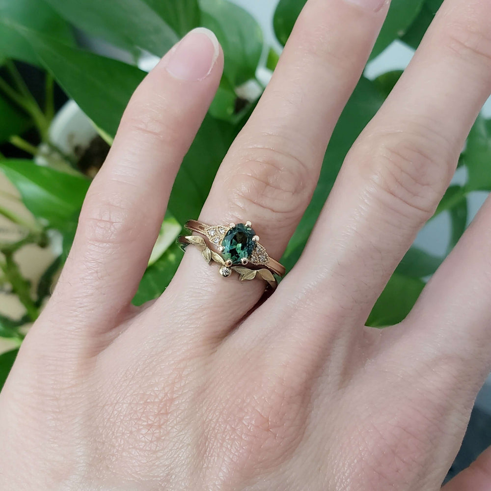Leafy rose gold wedding band with diamond stacked with green sapphire and diamond rings