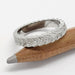 Leafy white gold wedding ring with Canadian diamonds, displayed on pencil