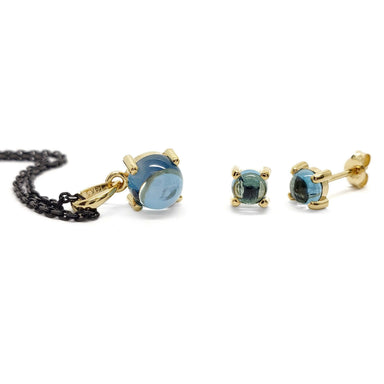 London blue topaz pendant and stud earrings in 14kt yellow gold on a black chain